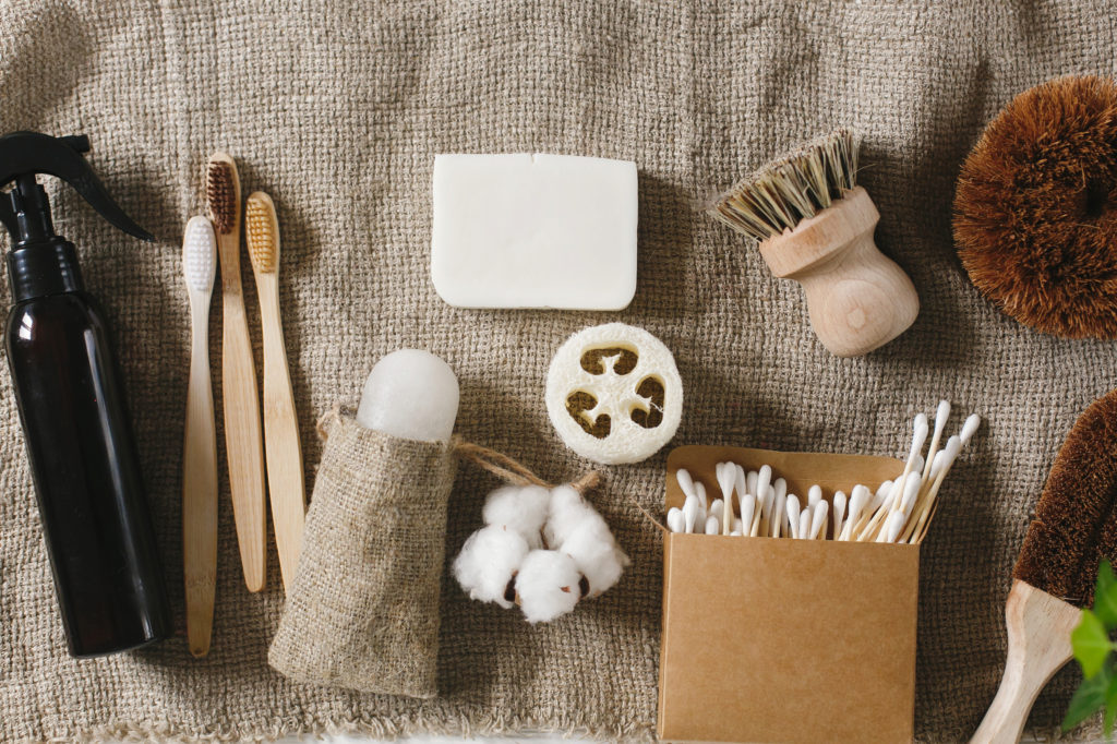 eco natural bamboo toothbrush, crystal deodorant,luffa, coconut soap,brushes,ear sticks, cotton. zero waste flat lay. home essentials, plastic free items. sustainable lifestyle concept
